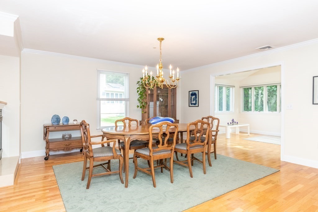 216 Rangeway Road, Unit 161 Billerica, MA 01862 - Photo 9 of 39 a dining room with furniture a chandelier and wooden floor