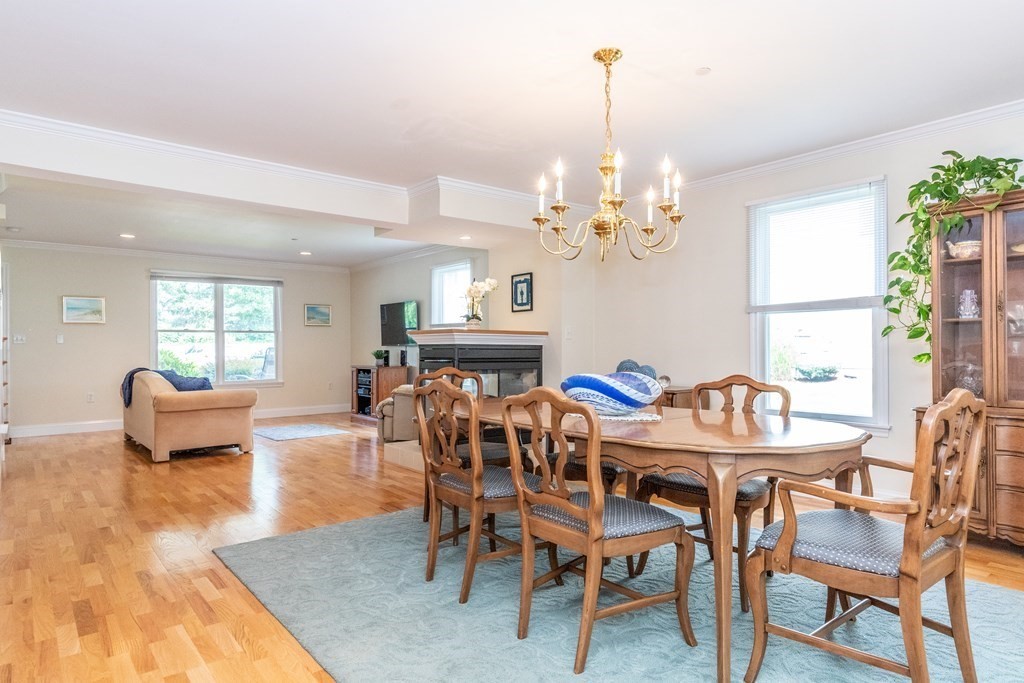 216 Rangeway Road, Unit 161 Billerica, MA 01862 - Photo 10 of 39 a view of a dining room with furniture a chandelier and wooden floor