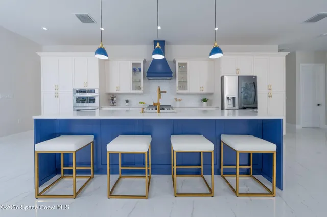 a living room with furniture a dining table and a potted plant