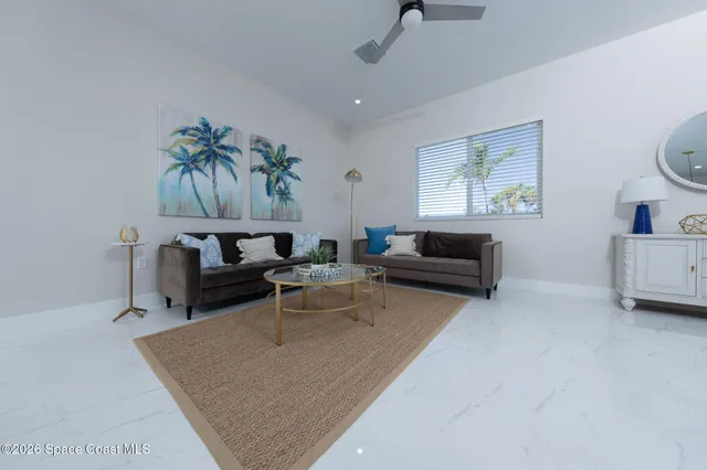 a living room with two bed and a couch