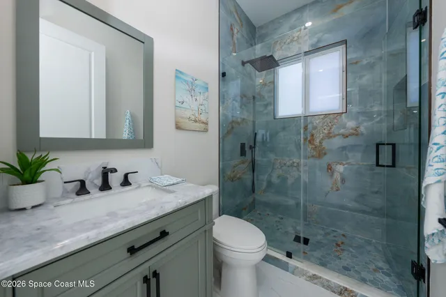 a bedroom with windows and closet