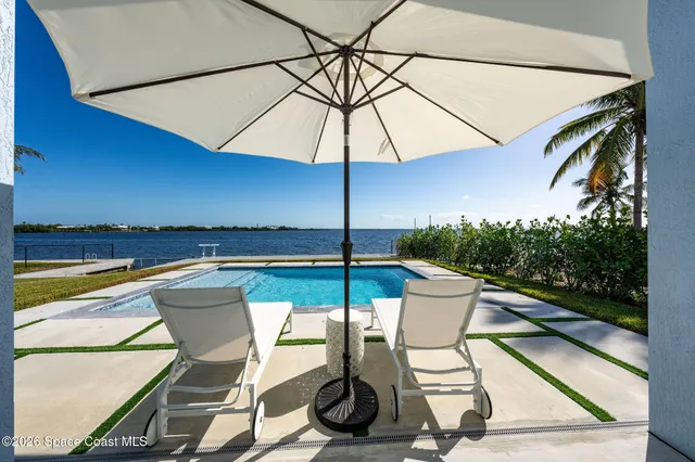 a view of a swimming pool with lounge chairs