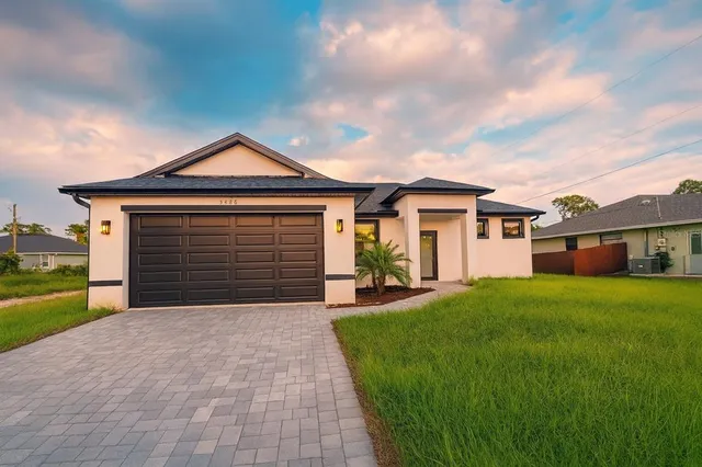 a front view of a house with a yard and garage