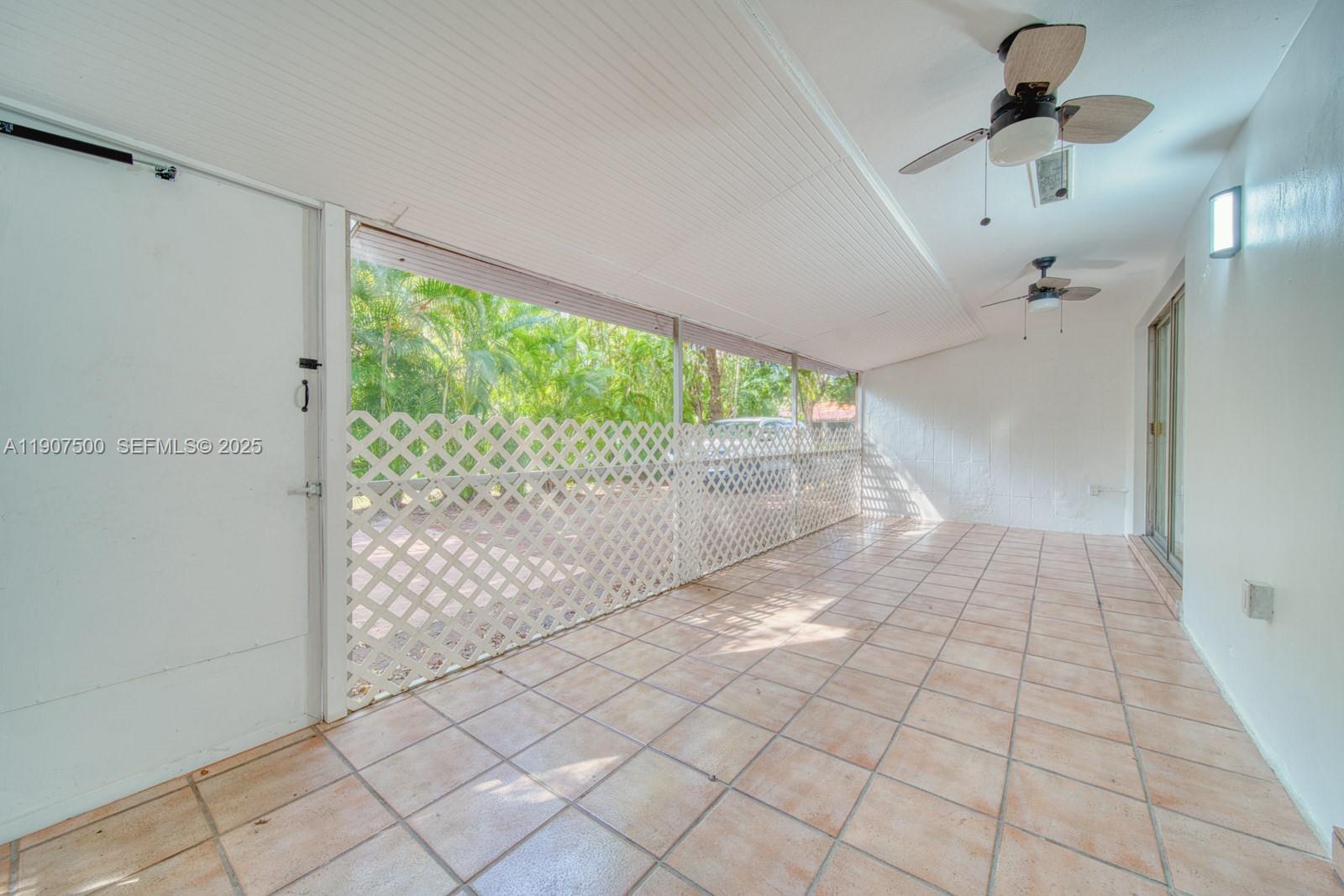 400 Minorca Avenue, Unit 1 Coral Gables, FL 33134 - Photo 11 of 21 a view of empty room with wooden floor and fan