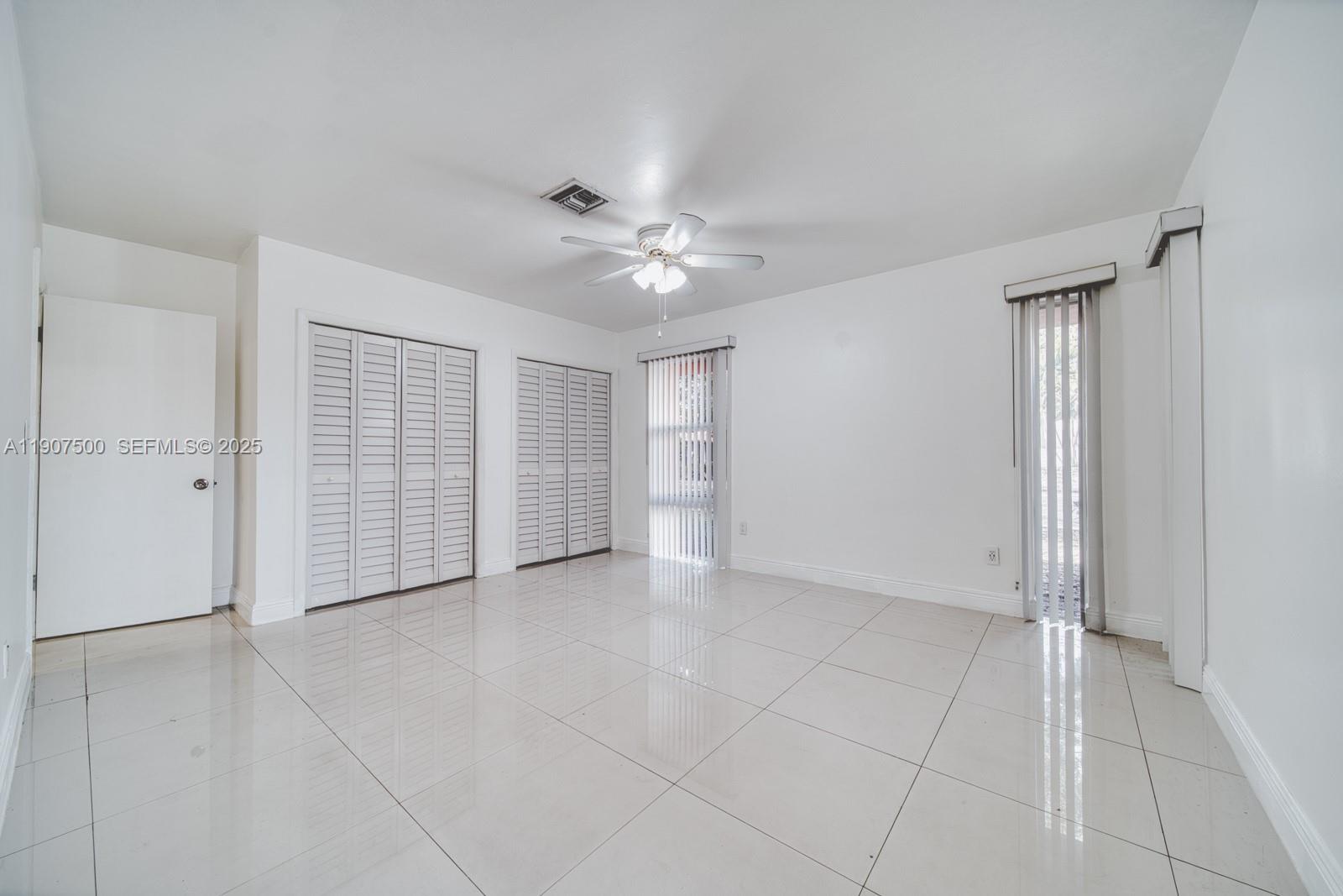 400 Minorca Avenue, Unit 1 Coral Gables, FL 33134 - Photo 12 of 21 a view of an empty room with a ceiling fan