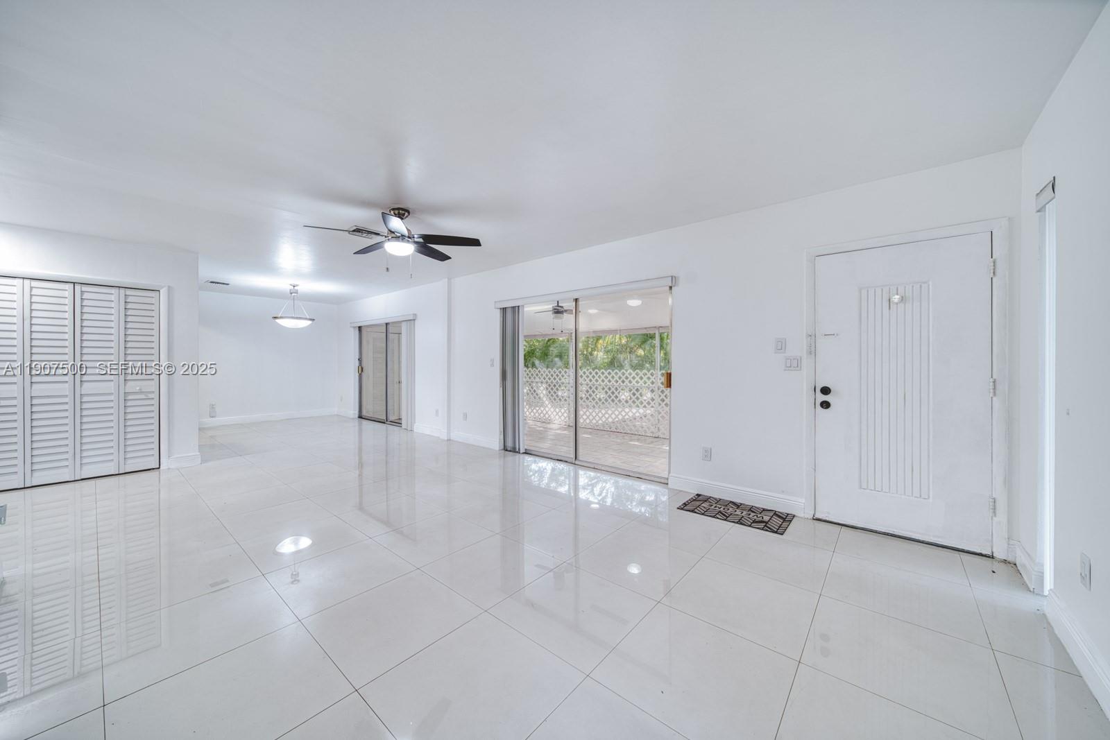 400 Minorca Avenue, Unit 1 Coral Gables, FL 33134 - Photo 14 of 21 a view of a livingroom with a ceiling fan and window