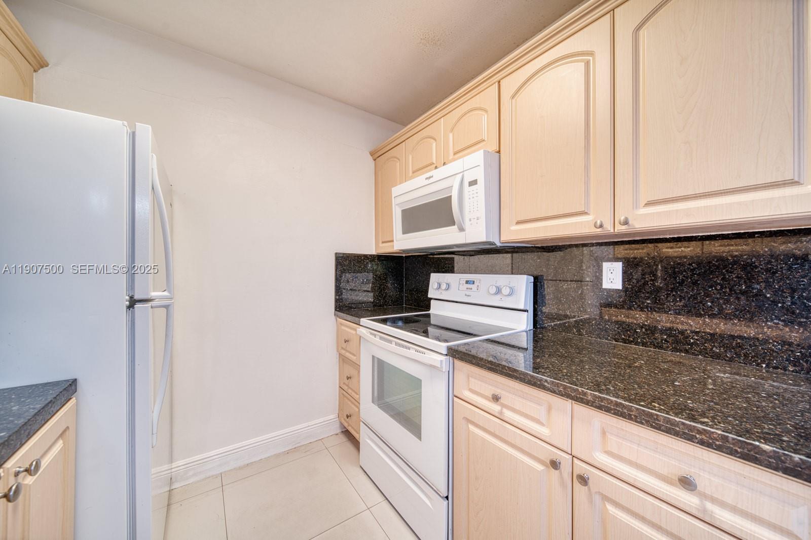 400 Minorca Avenue, Unit 1 Coral Gables, FL 33134 - Photo 17 of 21 a kitchen with stainless steel appliances granite countertop a sink and a granite counter tops