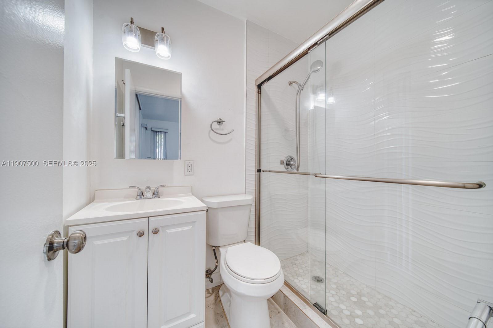 400 Minorca Avenue, Unit 1 Coral Gables, FL 33134 - Photo 3 of 21 a bathroom with a sink toilet and shower