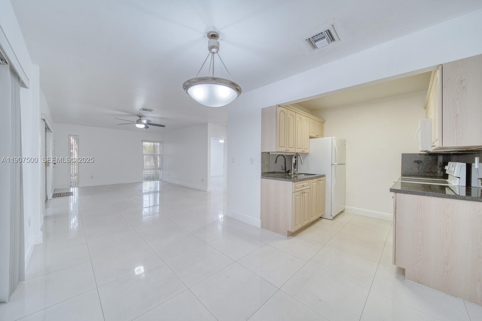400 Minorca Avenue, Unit 1 Coral Gables, FL 33134 - Photo 6 of 21 a view of a kitchen with a sink stainless steel appliances and cabinets