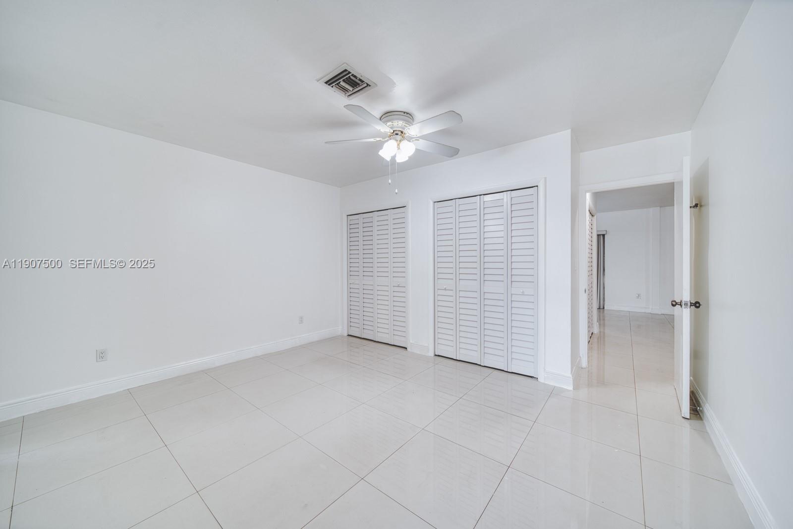 400 Minorca Avenue, Unit 1 Coral Gables, FL 33134 - Photo 10 of 21 an empty room with a ceiling fan and a shower