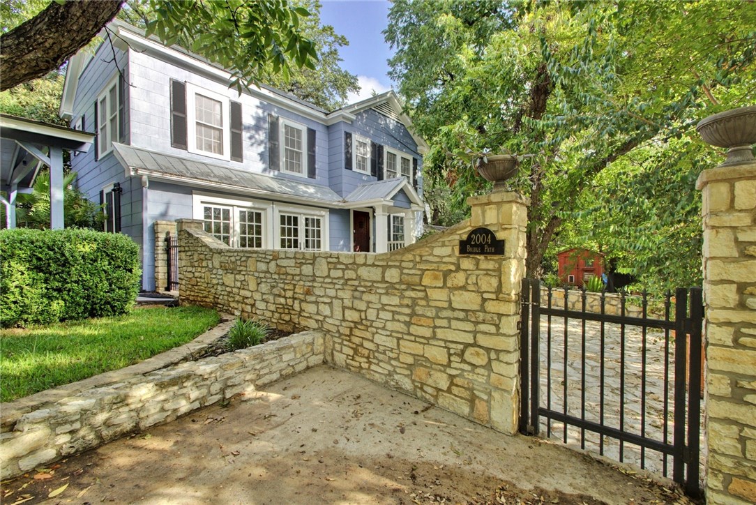 2004 Bridle Path Austin, TX 78703 - Photo 1 of 1 a front view of a house with a garden
