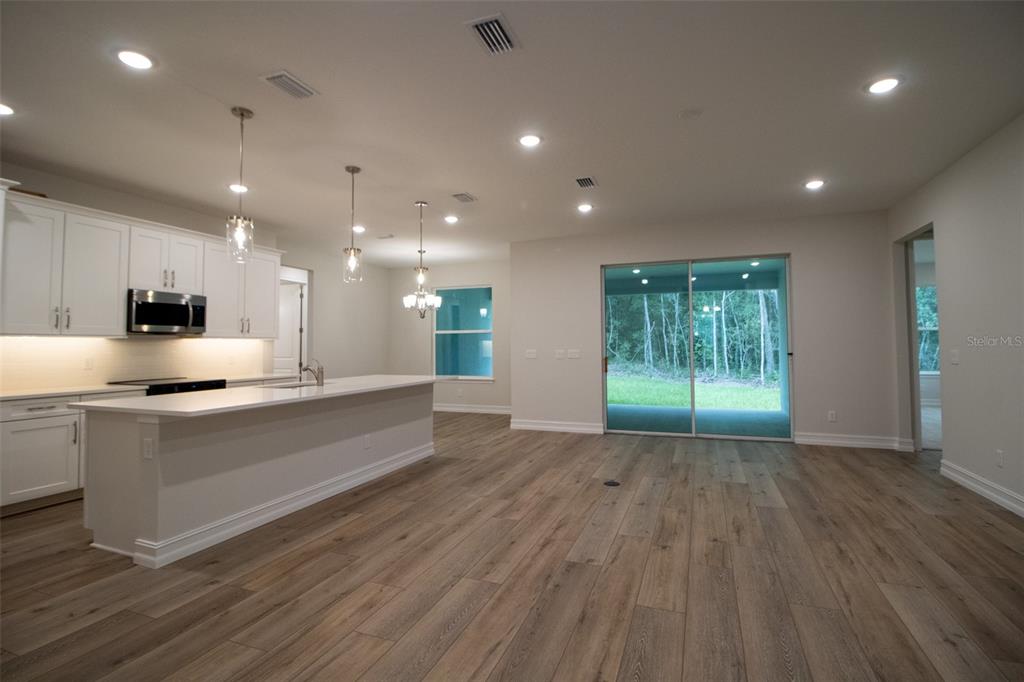 159 North Kinglet Avenue Hernando, FL 34442 - Photo 12 of 33 a large kitchen with stainless steel appliances a large counter top a sink and a refrigerator