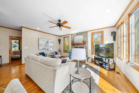 a living room with fireplace furniture and a large window