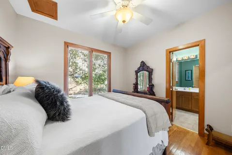 a bedroom with a bed and dresser with mirror