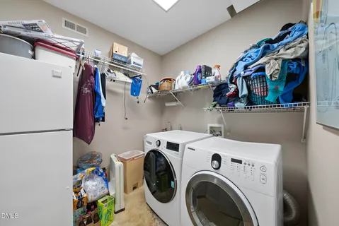 a view of storage and utility room with washer and dryer