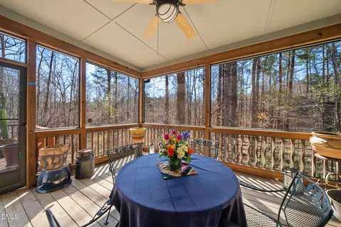 a view of a dining room with furniture large windows and wooden floor