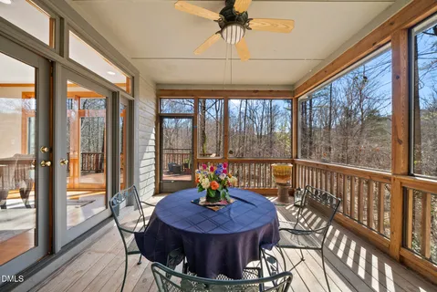 a view of a balcony with two chairs and a potted plant on a table