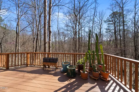 a view of balcony with wooden floor and fence