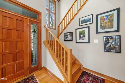 a view of a house with a yard and large tree
