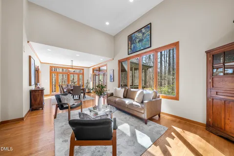 a living room with furniture and large windows