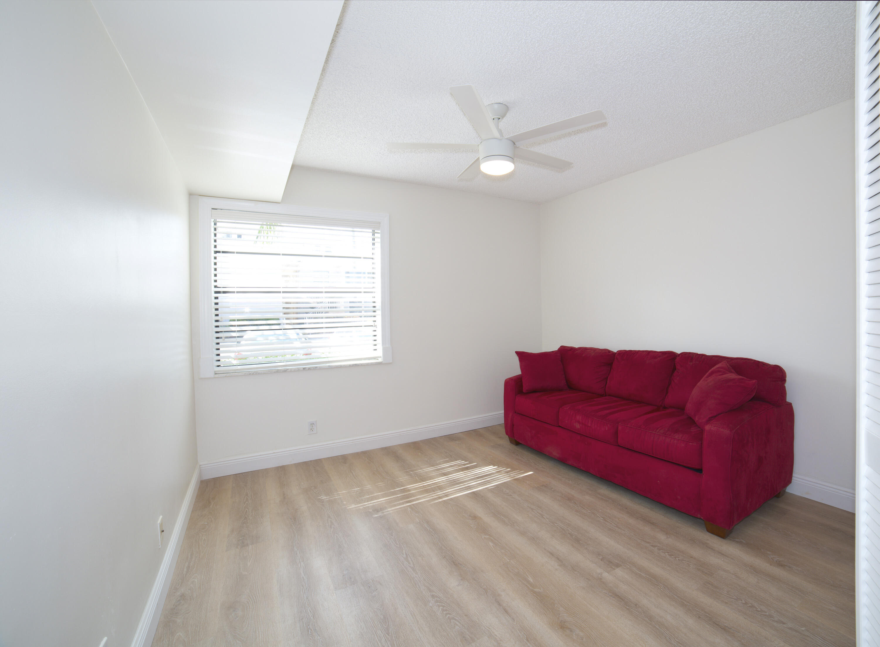 247 Capri F Delray Beach, FL 33484 - Photo 11 of 30 a living room with furniture and a window
