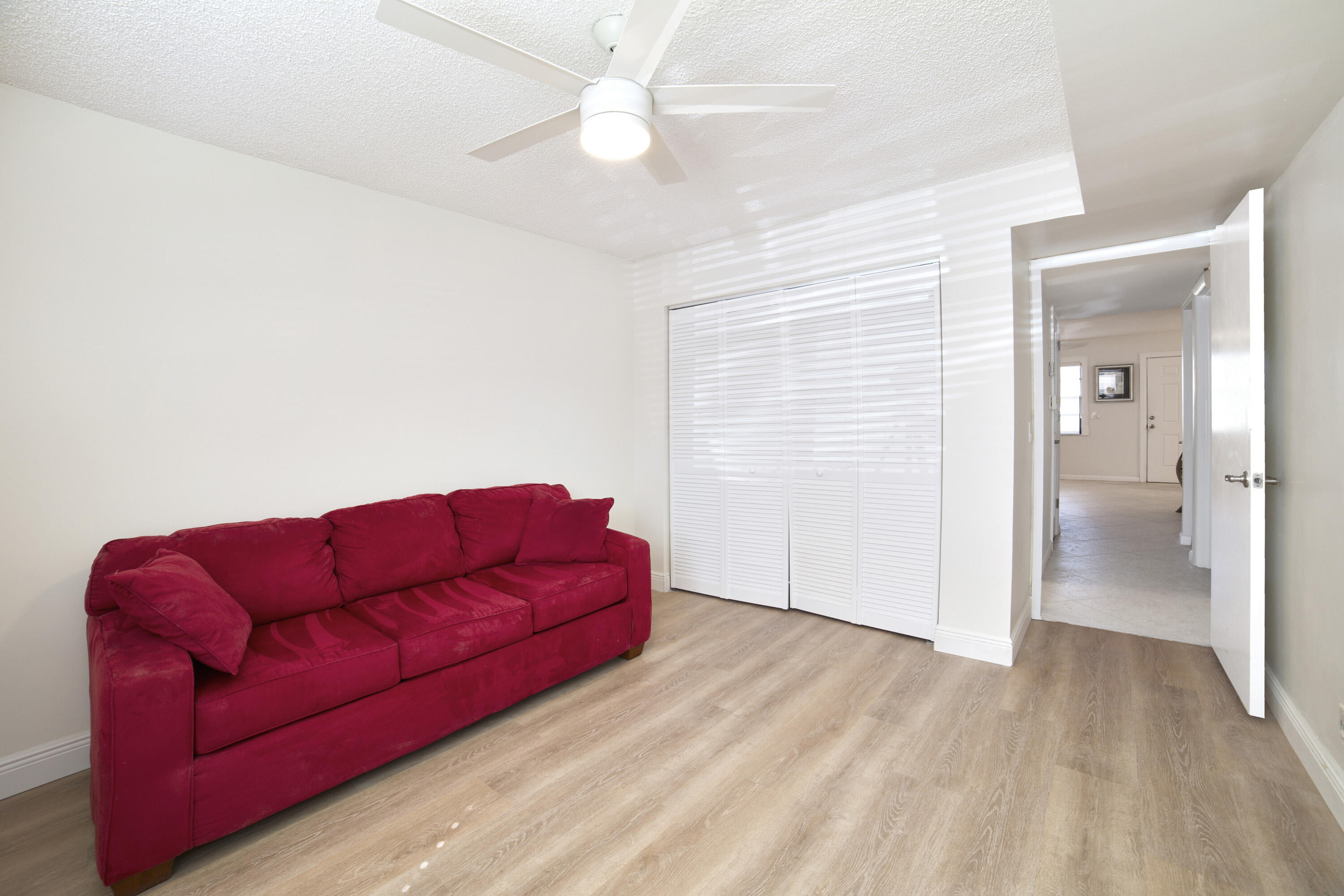 247 Capri F Delray Beach, FL 33484 - Photo 12 of 30 a living room with furniture and a wooden floor