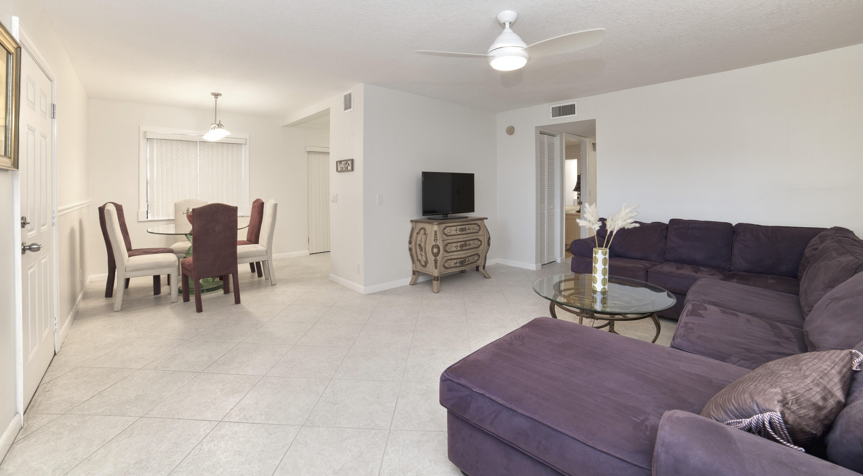 247 Capri F Delray Beach, FL 33484 - Photo 13 of 30 a living room with furniture and a flat screen tv