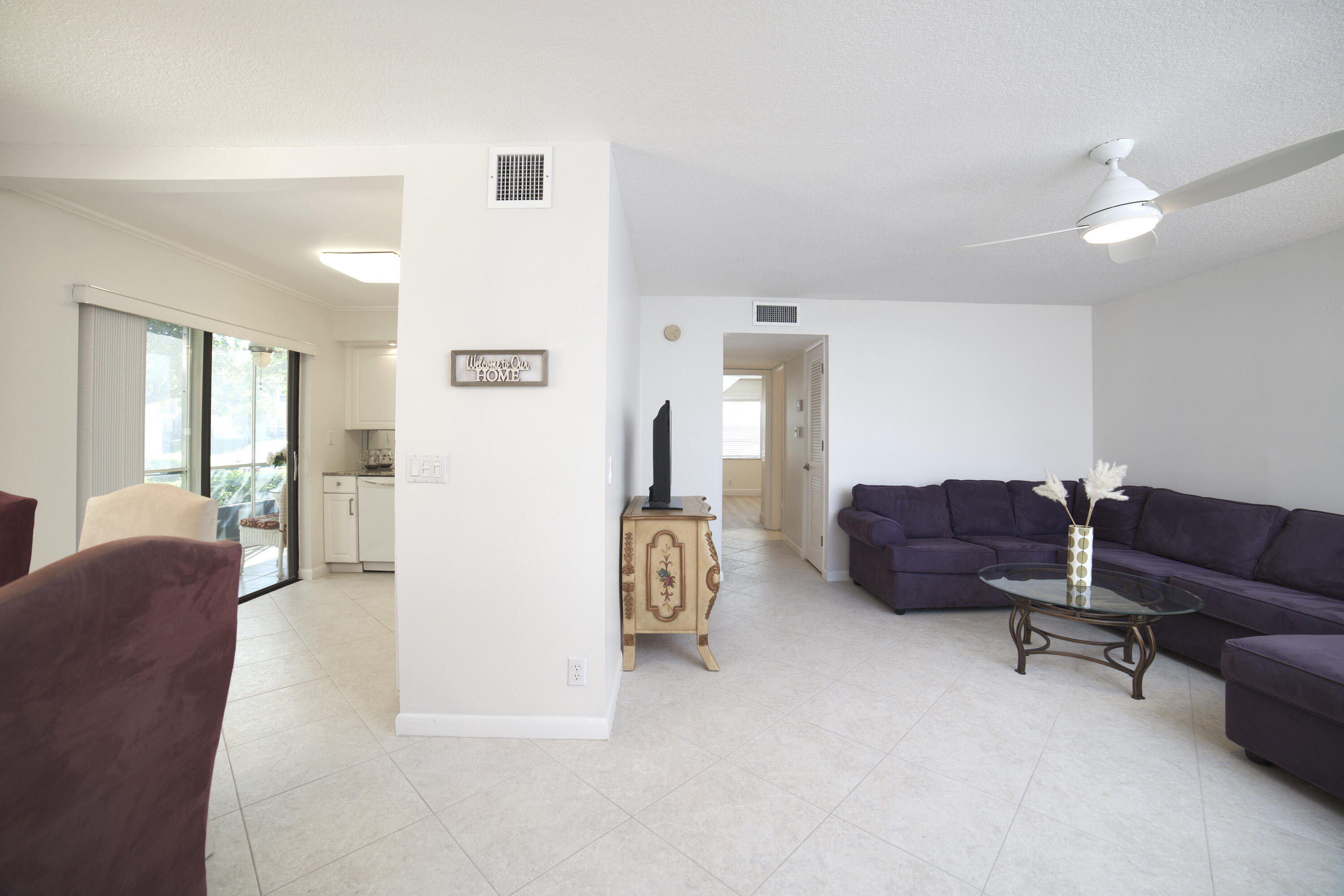 247 Capri F Delray Beach, FL 33484 - Photo 2 of 30 a living room with furniture and a lounge chair