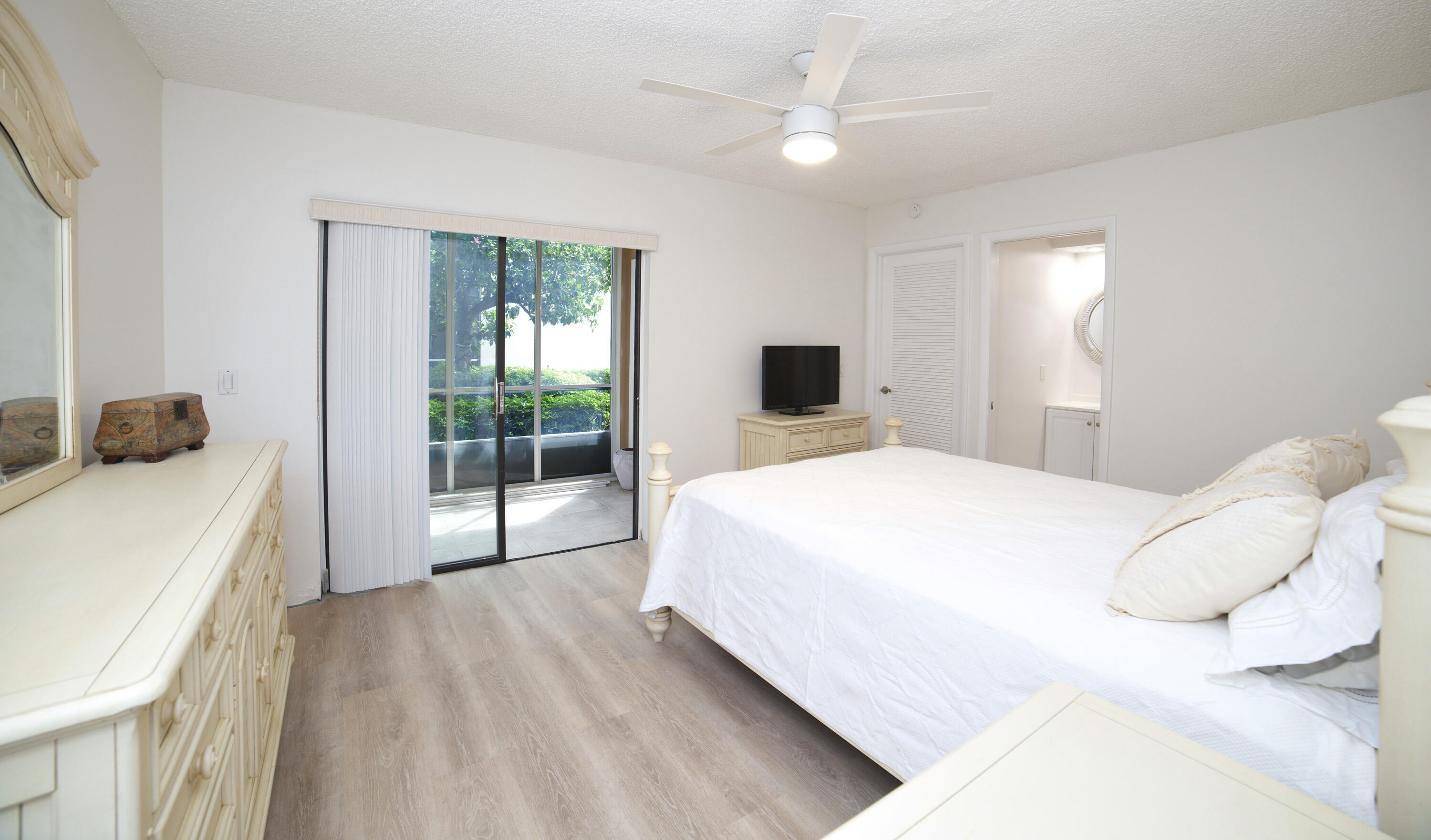247 Capri F Delray Beach, FL 33484 - Photo 8 of 30 a spacious bedroom with a bed and a window
