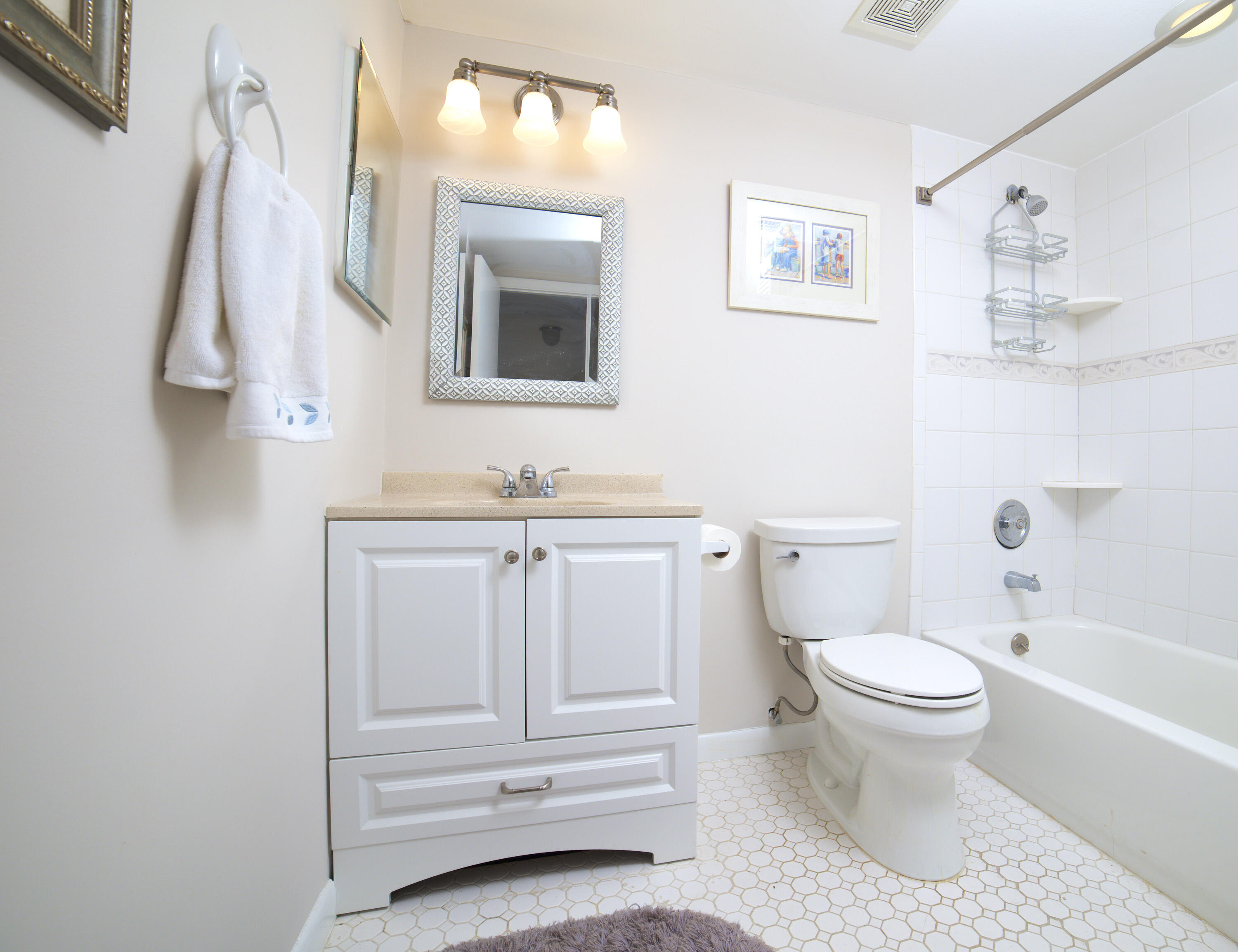 247 Capri F Delray Beach, FL 33484 - Photo 10 of 30 a bathroom with a toilet sink and a bathtub