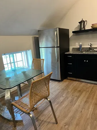 a bedroom with furniture and wooden floor