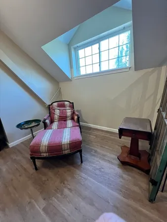 a bedroom with furniture and a window