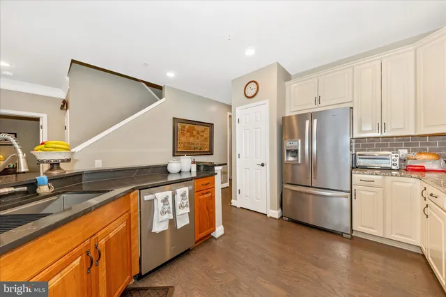 a view of a dining room with furniture a chandelier and wooden floor
