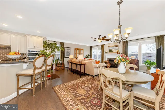 a living room with furniture a ceiling fan and a fireplace