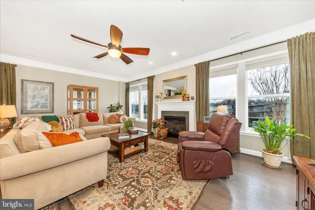 a living room with furniture and a view of kitchen