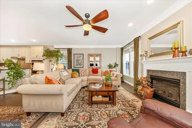 a living room with furniture kitchen view and a flat screen tv