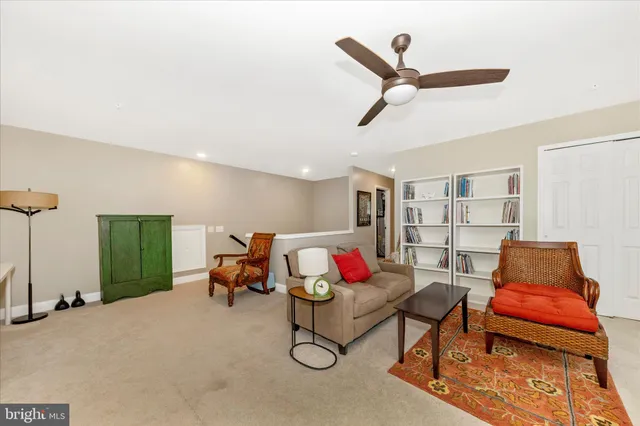 a living room with furniture rug and a window