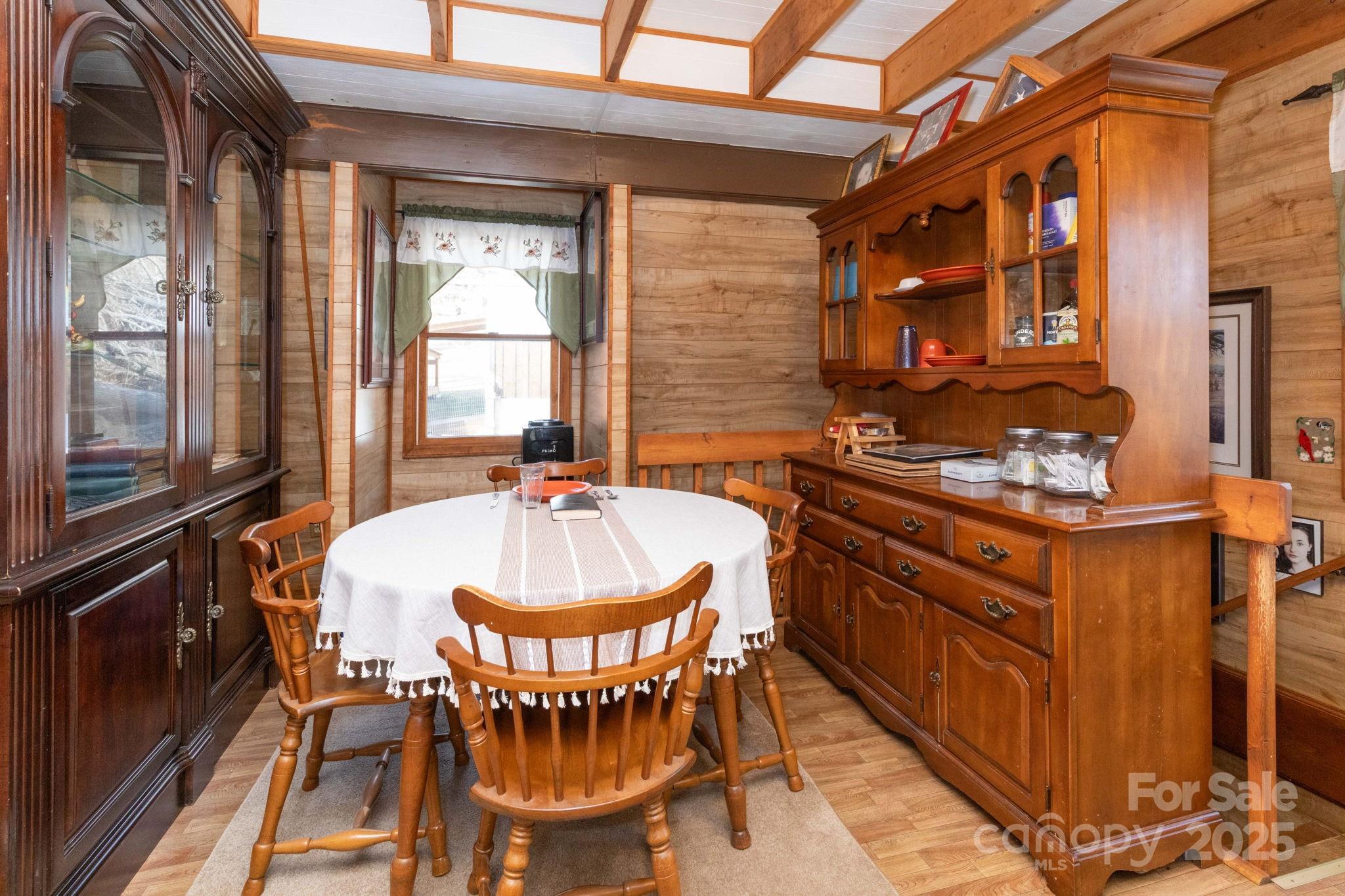 1010 Melton Branch Road Bakersville, NC 28705 - Photo 17 of 43 a dining room with furniture a window and chandelier