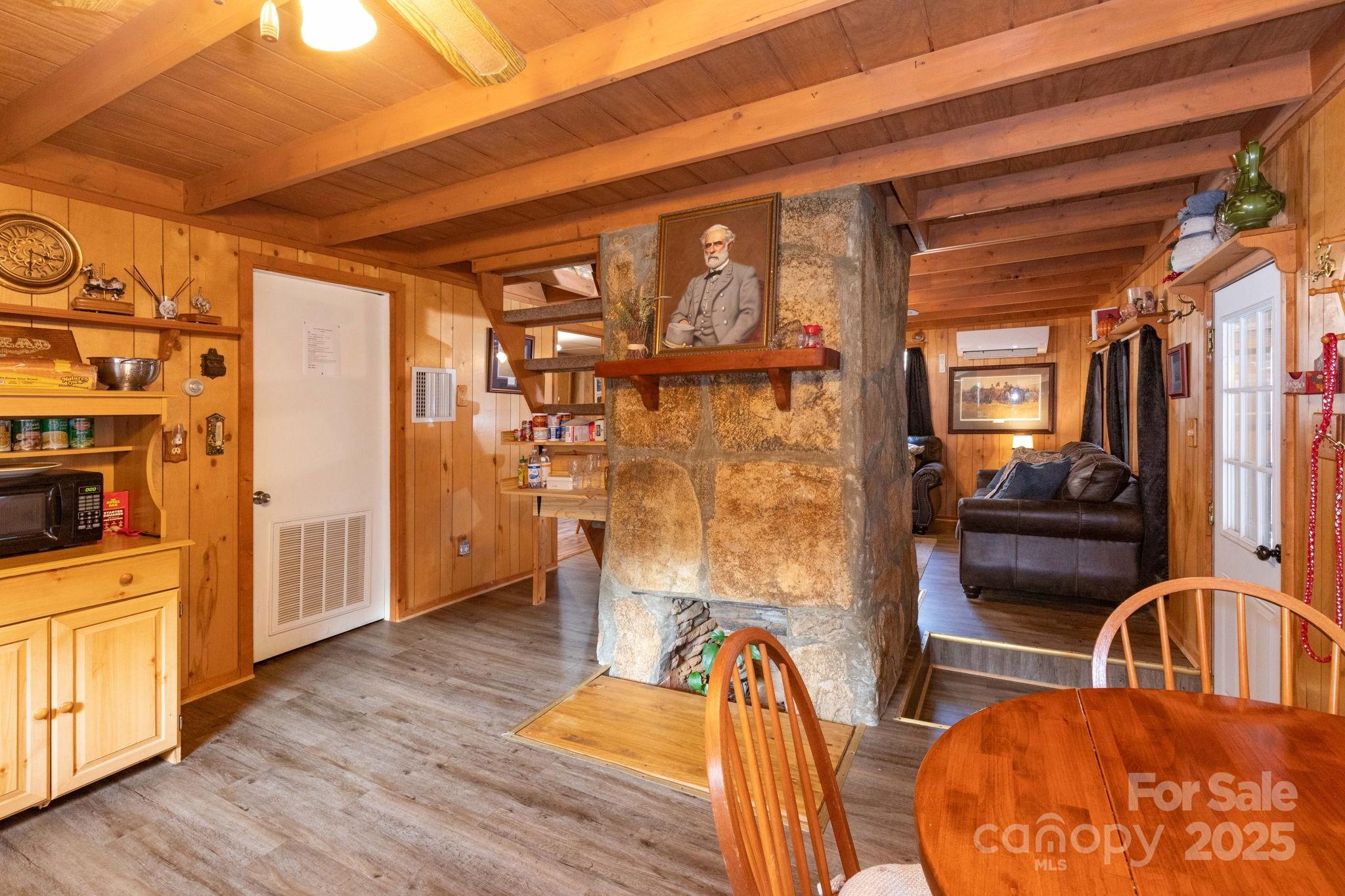 1010 Melton Branch Road Bakersville, NC 28705 - Photo 26 of 43 a view of a livingroom with furniture a dinning room and wooden floor
