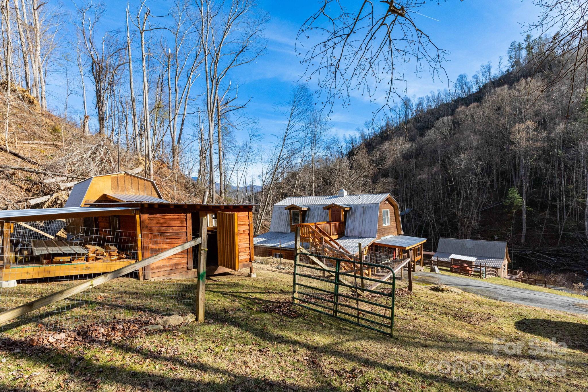 1010 Melton Branch Road Bakersville, NC 28705 - Photo 35 of 43 a view of a house with backyard and sitting area