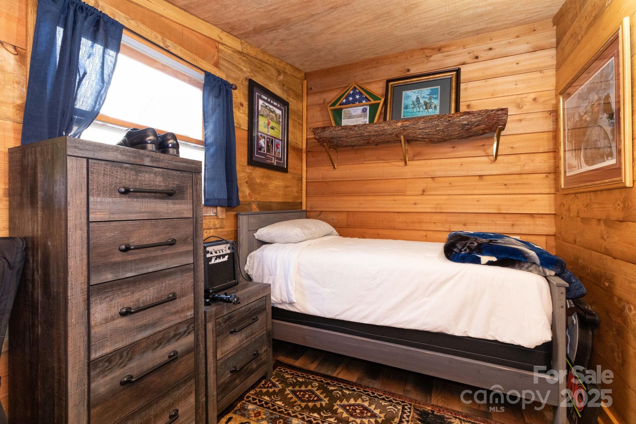 1010 Melton Branch Road Bakersville, NC 28705 - Photo 10 of 43 a bedroom with a bed and a window