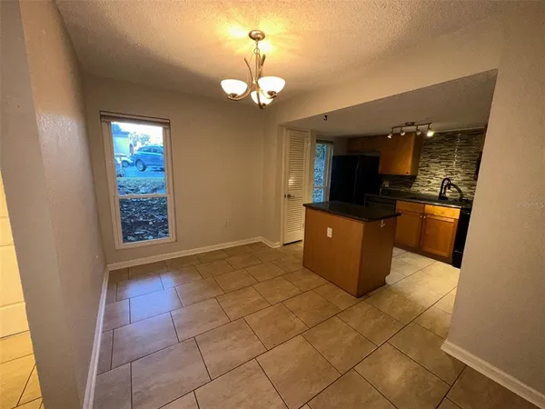 an empty room with wooden floor and a window