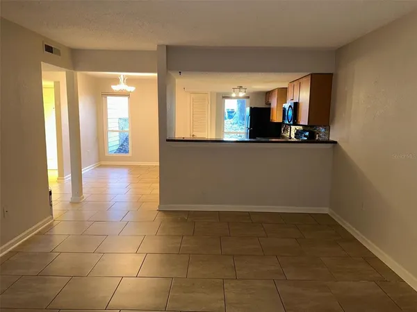 a view of a kitchen with an empty space and a window