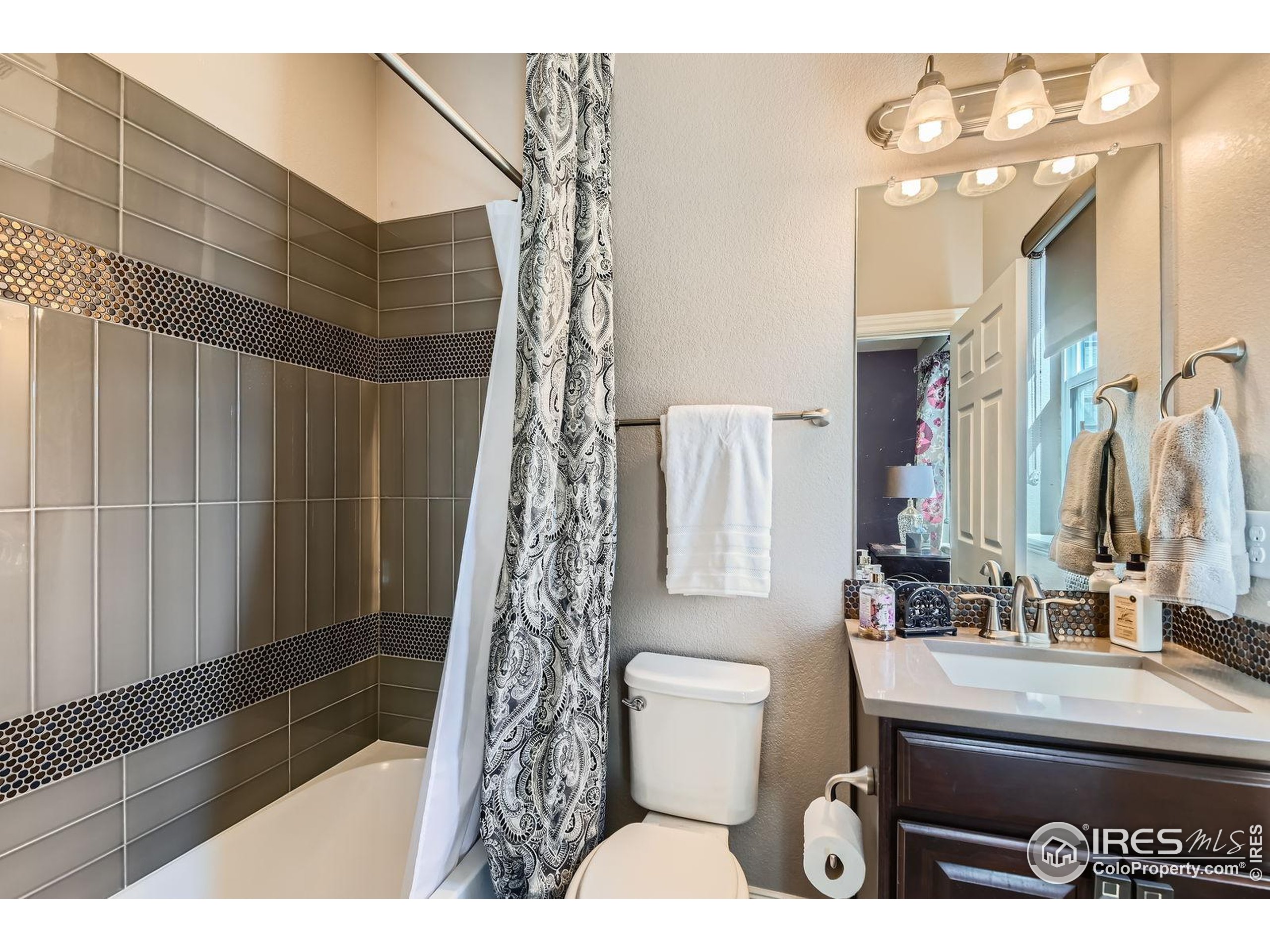 10834 Graphite Street Broomfield, CO 80021 - Photo 12 of 34 a bathroom with a sink toilet and shower