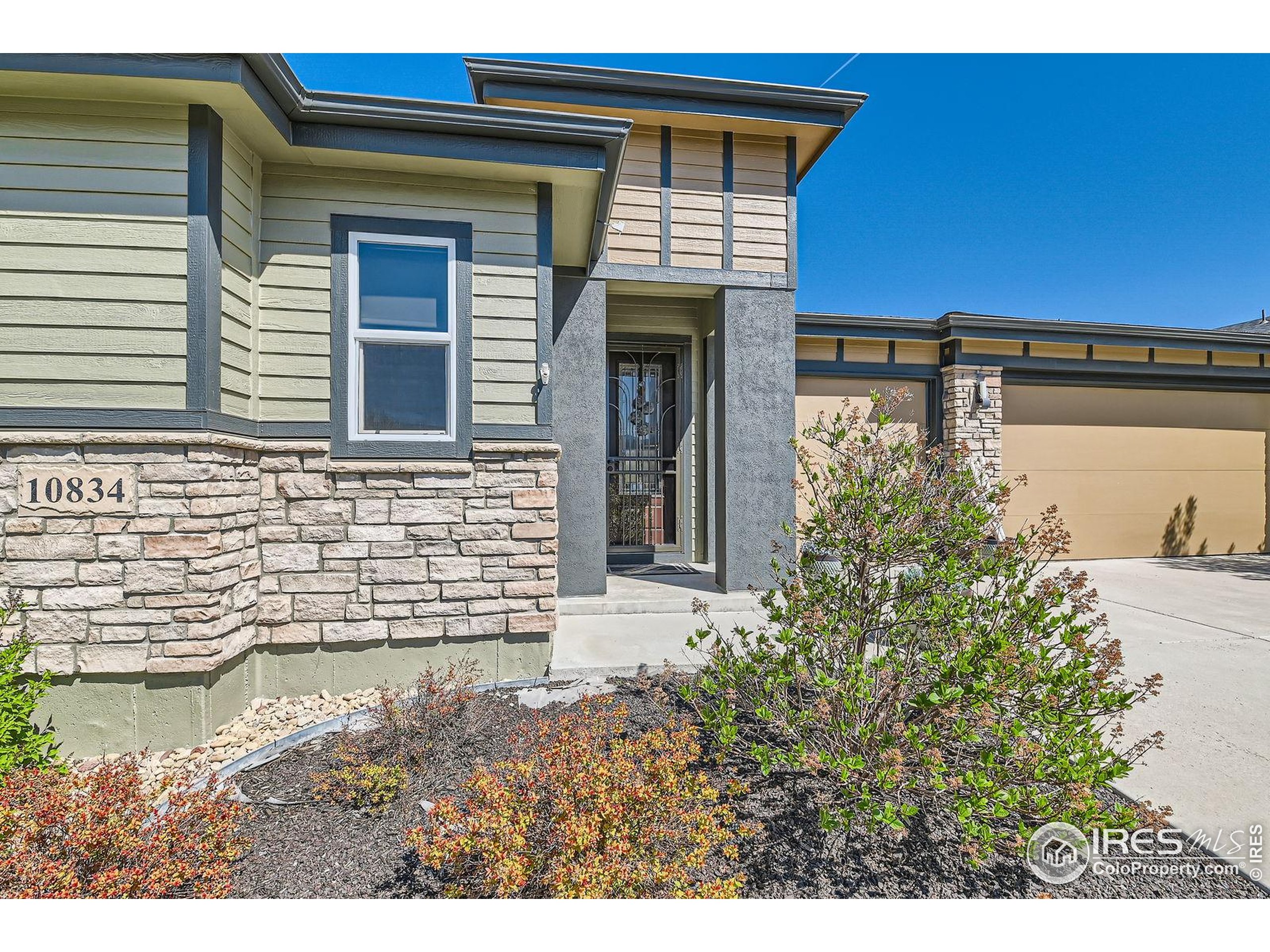 10834 Graphite Street Broomfield, CO 80021 - Photo 2 of 34 a front view of a house with a yard
