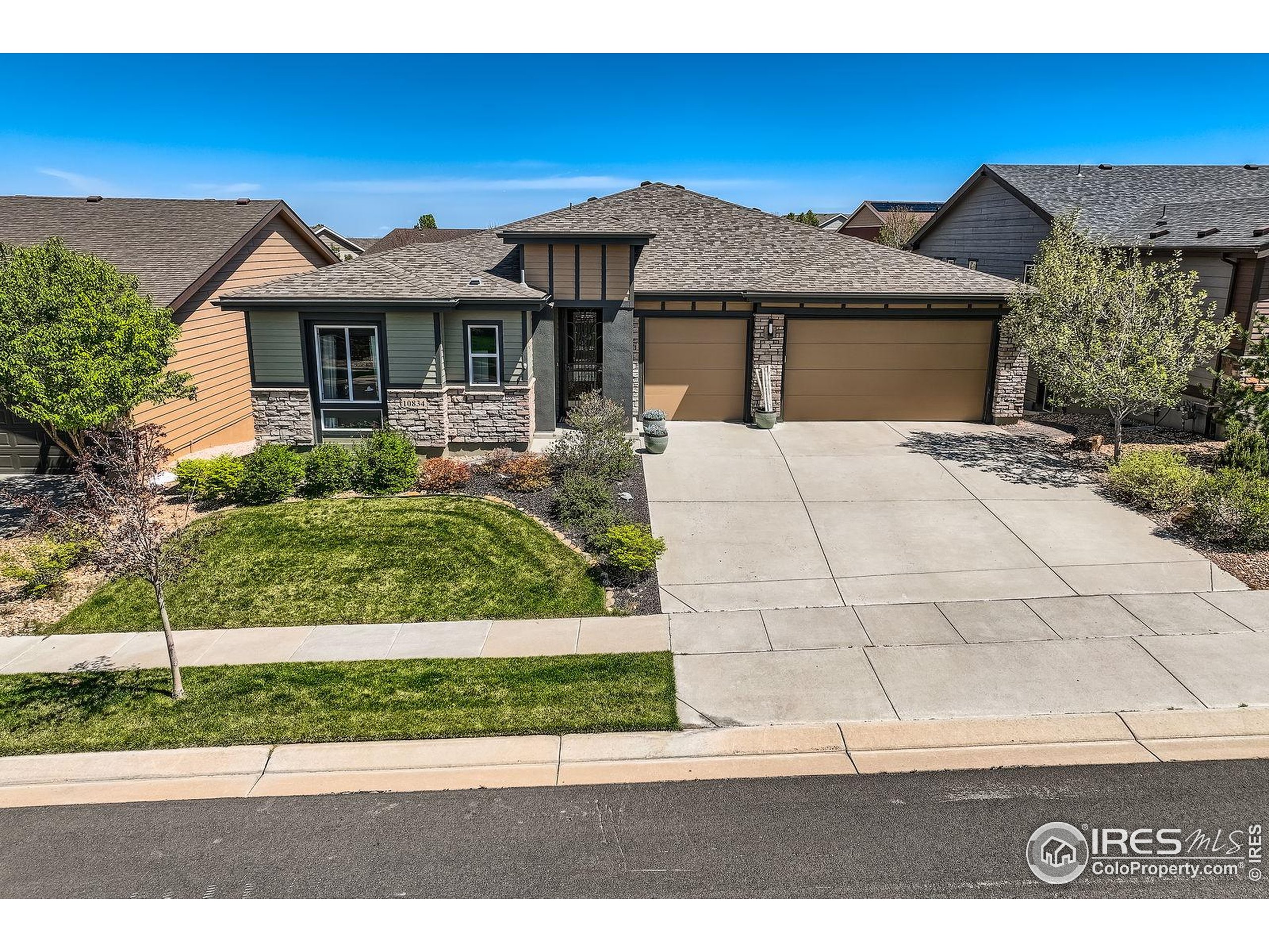 10834 Graphite Street Broomfield, CO 80021 - Photo 28 of 34 a front view of a house with a garden