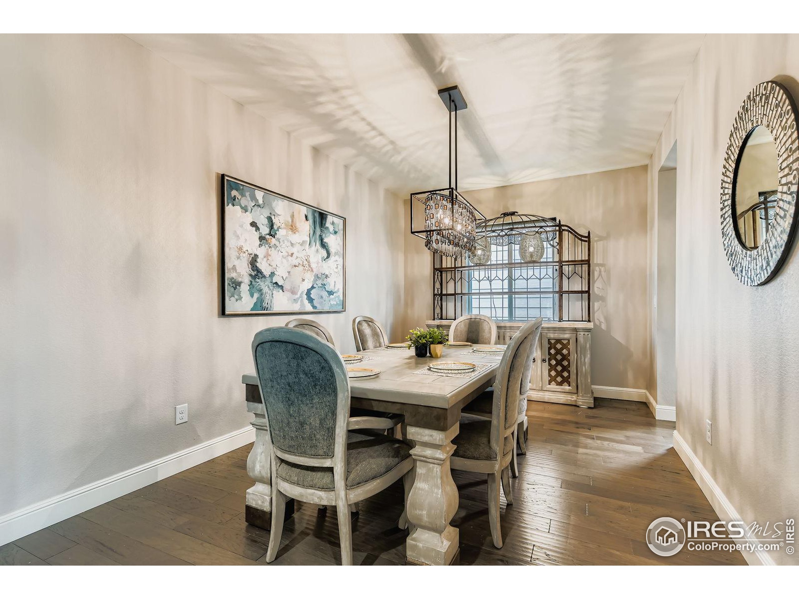 10834 Graphite Street Broomfield, CO 80021 - Photo 9 of 34 a view of a dining room with furniture window and wooden floor
