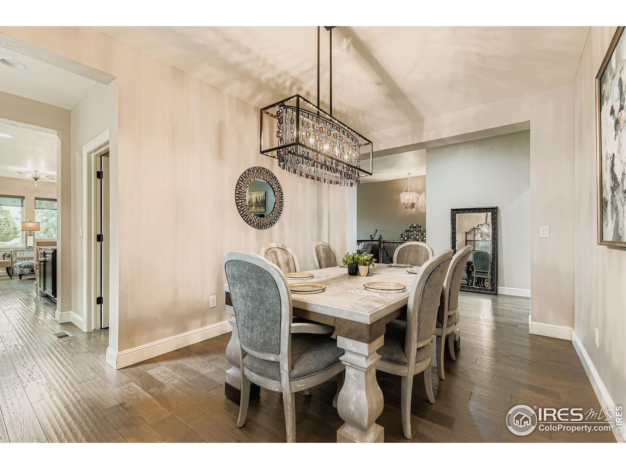 10834 Graphite Street Broomfield, CO 80021 - Photo 10 of 34 a view of a dining room and livingroom with furniture wooden floor a chandelier