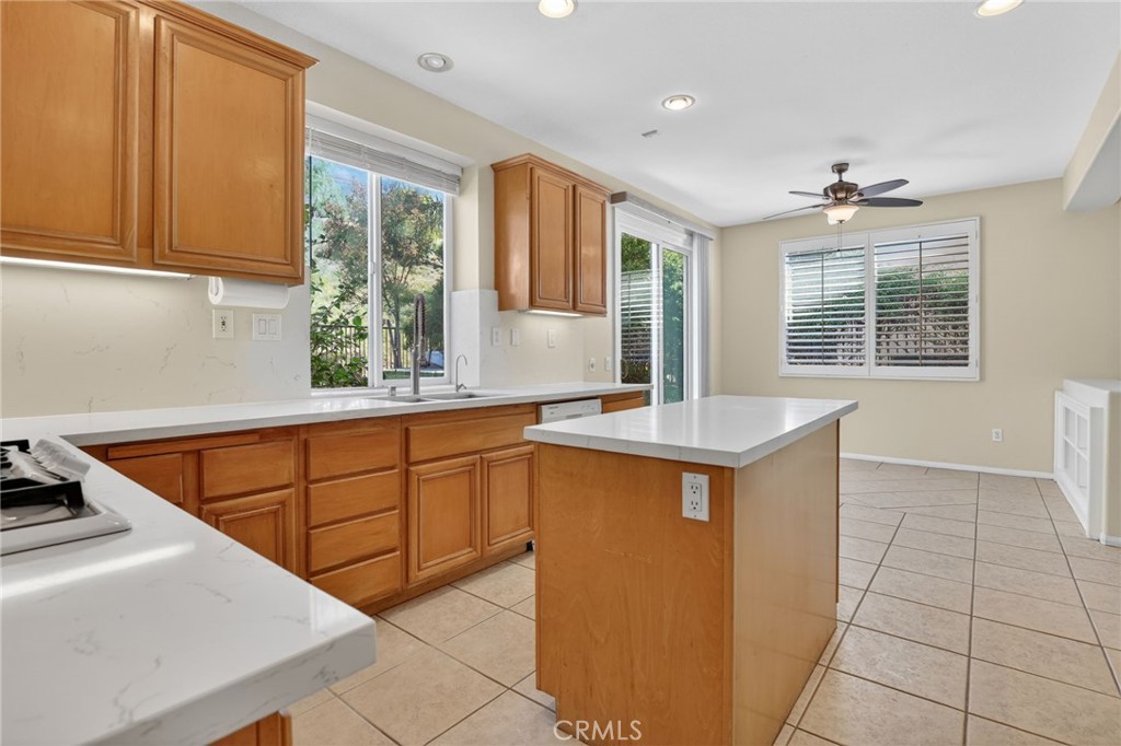 20543 Pesaro Porter Ranch Porter Ranch, CA 91326 - Photo 21 of 67 a kitchen with stainless steel appliances granite countertop a sink counter space cabinets and a window