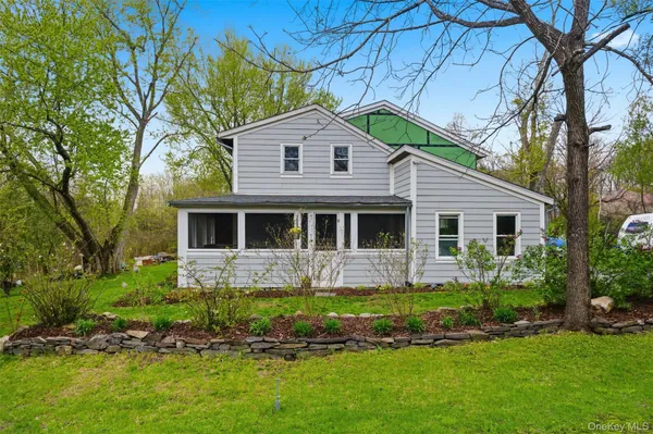 a front view of a house with a yard and porch